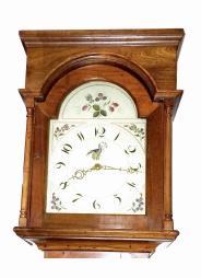 England, tall clock, 30 hour, time and strike, weight driven bell strike movement in an American-made walnut case with flat top, painted metal dial with floral elements, pierced brass hands.
