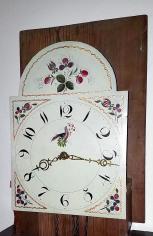 England, tall clock, 30 hour, time and strike, weight driven bell strike movement in an American-made walnut case with flat top, painted metal dial with floral elements, pierced brass hands.