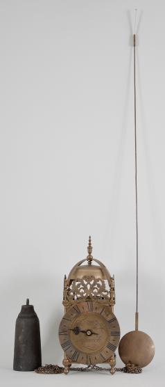 Clocks- 2 (Two): (1) Gebrüder Junghans AG, Schramberg, Germany, Vienna style wall clock, time and strike, spring driven brass movement in a walnut case with keyhole-form window, white enamel dial, blackened steel hands, c1880; (2) Eastern Europe, reproduction lantern clock, 30 hour, time and strike, weight driven brass movement with recoil escapement in a posted brass frame with pierced crest, turned finials, and brass dial, single blackened brass hand, all on a figured walnut bracket, c1970.