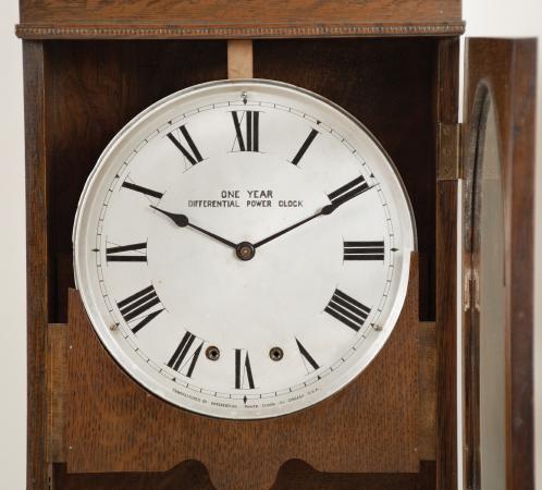 Clocks- 3 (Three): (1) National Time Recorder Co., London, England, master clock, brass movement with electrically impulsed pendulum in a mahogany case with painted metal dial, c1940; (2) Differential Power Clock Co., Chicago, "One Year Differential Power Clock" wall clock, year running, time only, driven by two springs brass movement in a robust oak case and with signed metal dial, c1910; (3) McClintock-Loomis Company, Minneapolis, Minn., master clock, 8 day, time and program mechanism, spring driven brass clock movement and second spring driven program movement in a wood case with painted copper dial, c1930.
