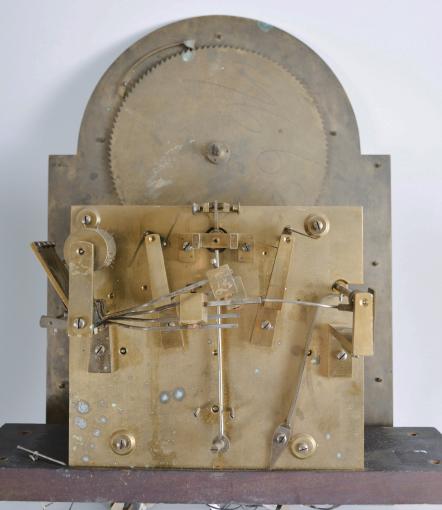 Unknown, England, hall clock, 8 day, time and strike with Westminster chimes, three train weight driven brass movement with deadbeat escapement in a walnut case with molded base, glazed door, and hood with broken arch, arched dial with silvered chapter ring with applied brass numerals, pierced and engraved spandrels and dial center, moon phase dial, chime / silent selector, and subsidiary seconds dial.