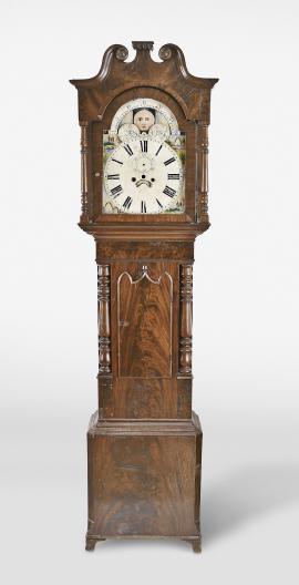 Parts- 2 (Two) tall clock cases: (1) Unknown, England, tall clock case and dial, walnut veneer case with turned half columns flanking the door together with painted metal dial with moon phase and date; (2) English tall clock case in dark wood, stepped base and swan