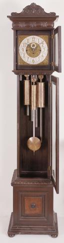 Colonial Clock Company, Zeeland, Mich., chiming hall clock, 8 day, time and strike with Westminster chime playing on tubes, weight driven brass Herschede movement in a walnut case with brass dial, silvered chapter ring with applied brass numerals, and black steel hands