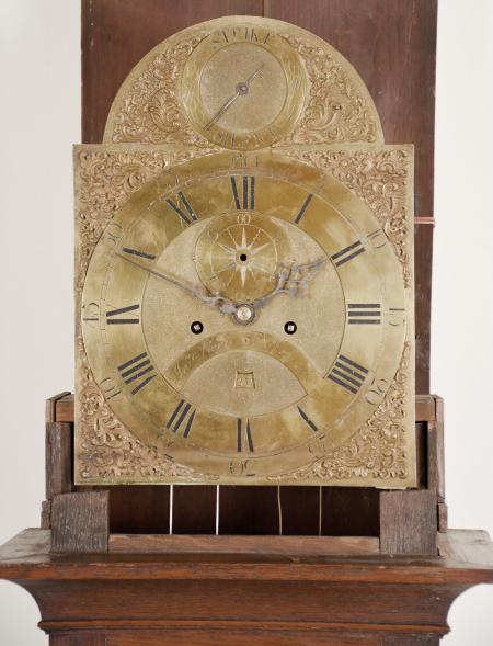 John Nevil, Norwich, England, longcase clock, 8 day, time and strike with date, weight driven brass movement in an oak case with flat-top hood with dentil molding, engraved brass dial with matte center and applied spandrels, subsidiary dials for seconds and strike/silent, blued steel hands.