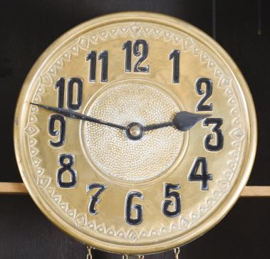 Friedrich Mauthe, Schwenningen, Germany, tall clock, 8 day, time and strike, weight driven brass movement in a dark oak case with frame and panel doors, stepped molded cornice, embossed brass dial with black steel hands.