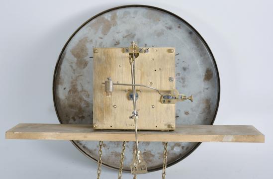 Friedrich Mauthe, Schwenningen, Germany, tall clock, 8 day, time and strike, weight driven brass movement in a dark oak case with frame and panel doors, stepped molded cornice, embossed brass dial with black steel hands.