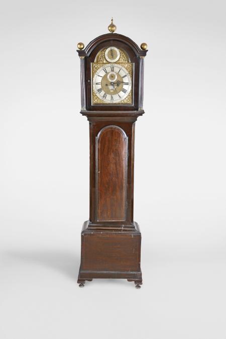 Charles Blanchard, London, England, tall clock, 8 day, time and strike, weight driven movement in a mahogany case on a base with inlaid front panel, the trunk with fluted, canted corners, the hood with broken arch, brass dial with silvered roman numeral chapter ring and applied brass spandrels, matte dial center with engraved plaque with the maker