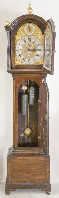 Charles Blanchard, London, England, tall clock, 8 day, time and strike, weight driven movement in a mahogany case on a base with inlaid front panel, the trunk with fluted, canted corners, the hood with broken arch, brass dial with silvered roman numeral chapter ring and applied brass spandrels, matte dial center with engraved plaque with the maker