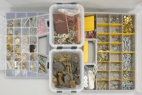 Parts- 6 (Six) boxes of clock parts including many mainsprings, dozens of keys, verges, cables & cord, fasteners, clock oil, wall hooks, gongs, many antique cast metal case parts, and more, together with a group of American and Swiss watch movements, crowns, and wrist watches.