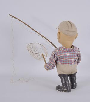 West Germany, clockwork advertising nodder figure, spring driven motor powering an up-and-down head motion, the paper-mâché fisherman figure with painted cast plaster of Paris head and hands, pivoted glass eyes, tailored shirt, leather belt with buckle, and felt cap, holding a fishing net in one hand and a wooden fishing rod in the other. 
