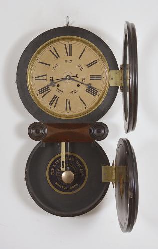 E. Ingraham & Co., Bristol, Conn., "Ionic Calendar" wall clock, 8 day, time and strike with B. B. Lewis perpetual calendar mechanism in a veneered and grain-painted case with two papered metal dials and black Maltese style hands.

