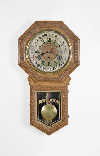 E.N. Welch Mfg. Co., Forestville, Conn., "Star Pointer" wall clock with a spring driven time and simple calendar movement in an oak case.