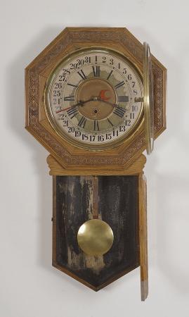 E.N. Welch Mfg. Co., Forestville, Conn., "Star Pointer" wall clock with a spring driven time and simple calendar movement in an oak case.