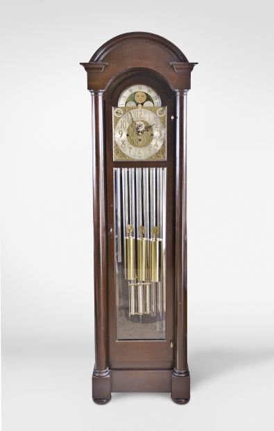 Herschede Clock Co., Cincinnati, Ohio, early 20th century tall clock with mahogany, stained dome top case with cavetto molded cornice on compressed ball feet and break arch door with beveled glasses, arabic numeral composite dial with silvered chapter ring, pierced and engraved gilt spandrels and dial center, moon phase display in the arch, and fancy blued steel hands, 8 day, three train movement chiming on tubes, and sounding Westminster, Whittington, or Canterbury quarters,  faux three jar mercury pendulum, and three polished brass weights.