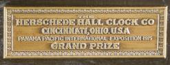 Herschede Clock Co., Cincinnati, Ohio, early 20th century tall clock with mahogany, stained dome top case with cavetto molded cornice on compressed ball feet and break arch door with beveled glasses, arabic numeral composite dial with silvered chapter ring, pierced and engraved gilt spandrels and dial center, moon phase display in the arch, and fancy blued steel hands, 8 day, three train movement chiming on tubes, and sounding Westminster, Whittington, or Canterbury quarters,  faux three jar mercury pendulum, and three polished brass weights.