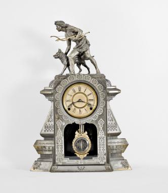 F. Kroeber Clock Co., New York, NY, "Indian Hunter V.P." mantel clock, 8 day, time and strike, spring driven brass movement in a metal front case depicting a hunter with a bow and arrow standing next to his alert canine companion, papered metal dial, and black steel Maltese style hands.