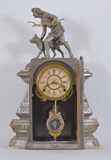 F. Kroeber Clock Co., New York, NY, "Indian Hunter V.P." mantel clock, 8 day, time and strike, spring driven brass movement in a metal front case depicting a hunter with a bow and arrow standing next to his alert canine companion, papered metal dial, and black steel Maltese style hands.