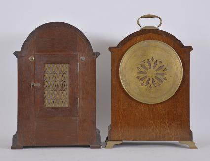 Clocks- 2 (Two) mantel: (1) Pearce & Sons Ltd., Leeds, England, mantel clock, 8 day, time and strike spring driven movement in a small bracket clock case with figured mahogany and inlaid flower design, roman numeral two-piece silvered dial, black steel hands, c1910; (2) Waltham Clock Co., Waltham, Mass., for Bigelow, Kennard & Co., Boston, mantel clock, 8 day, time and strike, spring driven balance wheel movement in a mahogany case with broken arch top and butterfly inlay, arabic numeral silvered dial, blued steel hands, c1920.