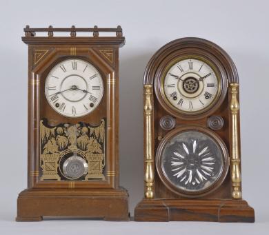 Clocks- 2 (Two): (1) Seth Thomas Clock Co., Thomaston, Conn., "Omaha" shelf clock with a spring driven 8 day time and strike (cathedral gong) lyre movement in a walnut case with gilt banding, c1888. (2) E. Ingraham & Co., Bristol, Conn., "Venetian No. 2, Extra" shelf clock with a spring driven 8 day time, strike and alarm movement in a rosewood veneered case with gilt columns and a cut glass mirror in the door, c1881.