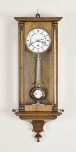 Clocks- 2 (Two): (1) E.N. Welch Manufacturing Co., Forestville, Conn., "Eclipse" wall clock, 8 day, time only with simple calendar, spring driven brass movement in a walnut case with papered metal dial, c1889; (2) Lenzkirch AG, Lenzkirch, Germany, wall clock or "RA" clock, 8 day, time only, spring driven movement in a mahogany veneer case, two-piece roman numeral white enamel dial with black steel hands, c1882.