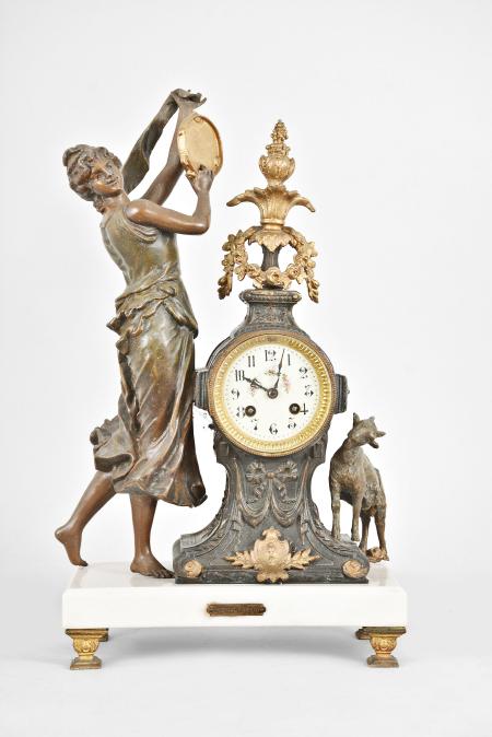 Fritz Marti & Fils, Paris, France, "Esmérelda" figural mantel clock, 8 day, time and strike, spring driven pendule de Paris movement, the case on cast feet supporting a polished white marble base, a goat figure on one side and a dancing woman with tambourine on the other, the clock with applied metal ornaments, arabic numeral white enamel dial with polychrome garlands in the center, blued steel hands.