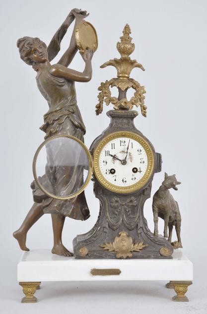 Fritz Marti & Fils, Paris, France, "Esmérelda" figural mantel clock, 8 day, time and strike, spring driven pendule de Paris movement, the case on cast feet supporting a polished white marble base, a goat figure on one side and a dancing woman with tambourine on the other, the clock with applied metal ornaments, arabic numeral white enamel dial with polychrome garlands in the center, blued steel hands.