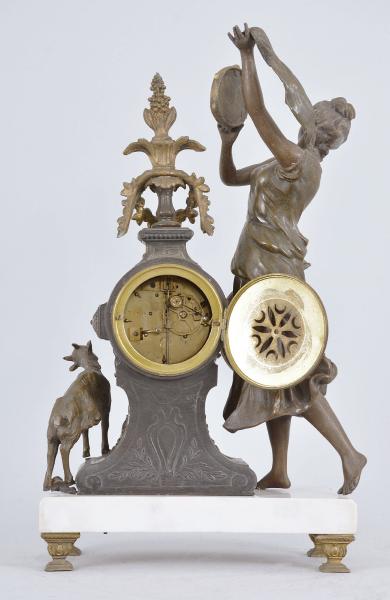Fritz Marti & Fils, Paris, France, "Esmérelda" figural mantel clock, 8 day, time and strike, spring driven pendule de Paris movement, the case on cast feet supporting a polished white marble base, a goat figure on one side and a dancing woman with tambourine on the other, the clock with applied metal ornaments, arabic numeral white enamel dial with polychrome garlands in the center, blued steel hands.