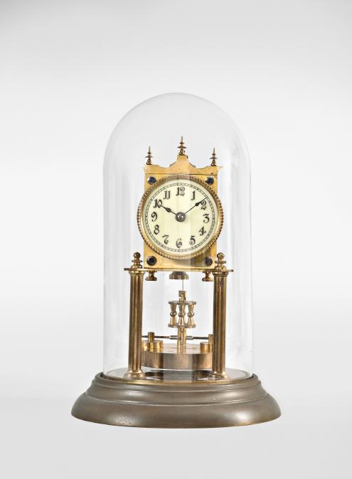 Jahresuhrenfabrik, Triberg, Germany, 400-day or "Anniversary Clock", year-running, spring driven movement with torsion pendulum and deadbeat escapement on brass base and posts, arabic numeral white enamel dial, black steel spade hands, and disc pendulum, all under a glass dome.