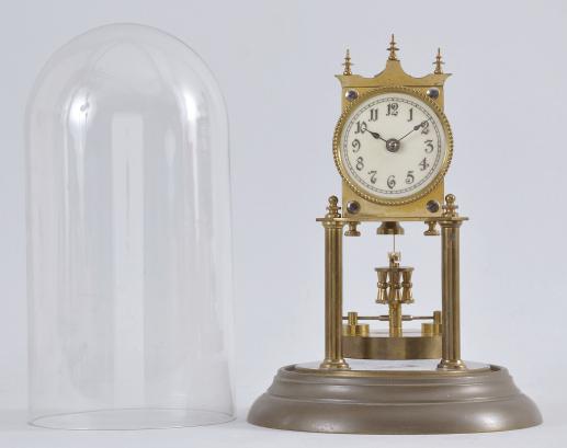 Jahresuhrenfabrik, Triberg, Germany, 400-day or "Anniversary Clock", year-running, spring driven movement with torsion pendulum and deadbeat escapement on brass base and posts, arabic numeral white enamel dial, black steel spade hands, and disc pendulum, all under a glass dome.
