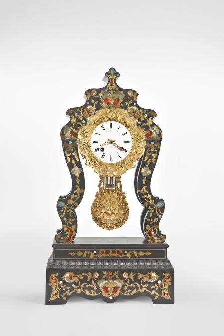 France, portico clock, 8 day, time and strike, spring driven movement with countwheel strike in an ebonized case with curved silhouette and stepped and molded base, the case front with abundant flower and scroll inlay of brass, tortoise shell, colored enamels and mother of pearl, heavy cast brass bezel surrounding a roman numeral white enamel dial, fancy pierced brass hands, and matching cast brass pendulum with faux gridiron.