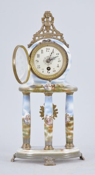 Japy Frères & Cie, Paris, France, mantel timepiece, 8 day, time only, spring driven movement in a polychrome ceramic case, the base on three cast metal feet, three columns supporting the clock decorated with mythical scenes and topped by a cast urn crest piece, arabic numeral white enamel dial and black steel hands.
