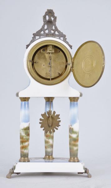 Japy Frères & Cie, Paris, France, mantel timepiece, 8 day, time only, spring driven movement in a polychrome ceramic case, the base on three cast metal feet, three columns supporting the clock decorated with mythical scenes and topped by a cast urn crest piece, arabic numeral white enamel dial and black steel hands.