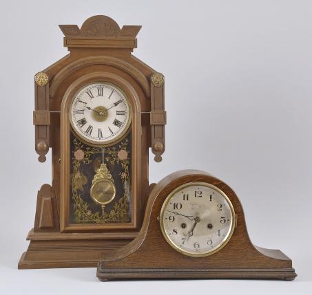 Clocks- 2 (Two): (1) New Haven Clock Co., New Haven, Conn., "Maas" shelf clock with a spring driven 8 day time, strike and alarm movement in a walnut case, c1883. (2) An unidentified German Tambour clock with a spring driven 8 day time and strike movement in a darkly finished case, c1910.