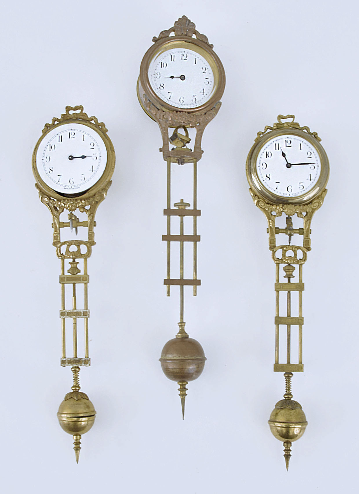 Three small swinging mystery clock movements including two by Junghans
