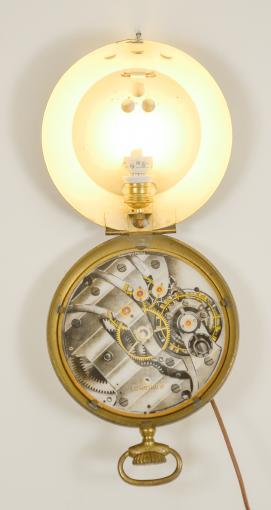 Longines, Switzerland, an interesting pocket watch form trade sign, brass case with steel back, arabic numeral, white painted glass dial with movement printed on reverse, and showing through the dial when the lamp is on