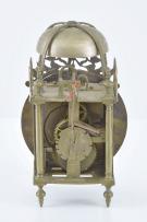 England, a miniature, 18th century lantern clock, the corners with continuous castings consisting of the turned feet, columns, and finials, the case top with strap mounted bell, and pierced, engraved fret above the 5" roman numeral brass dial with single brass hand, weight driven, brass, 30 hour movement with verge escapement and count wheel striking and passing strike at the half hour, back cock with thread suspension, resting on a purpose made oak wall bracket