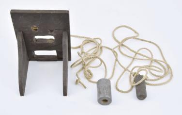 England, a miniature, 18th century lantern clock, the corners with continuous castings consisting of the turned feet, columns, and finials, the case top with strap mounted bell, and pierced, engraved fret above the 5" roman numeral brass dial with single brass hand, weight driven, brass, 30 hour movement with verge escapement and count wheel striking and passing strike at the half hour, back cock with thread suspension, resting on a purpose made oak wall bracket