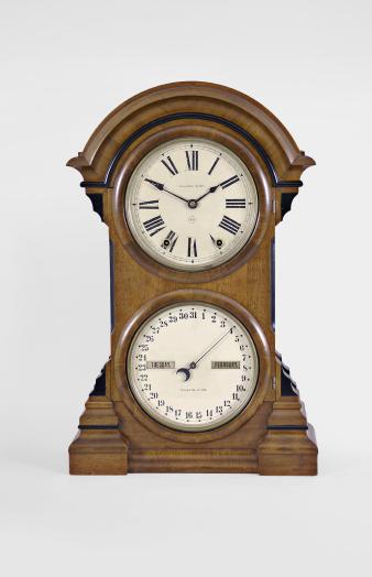 Seth Thomas Clock Co., Thomaston, Conn., "Parlor Calendar No. 4" with a spring driven 8 day time and strike movement with a R. T. Andrews patented perpetual calendar mechanism in a walnut case.