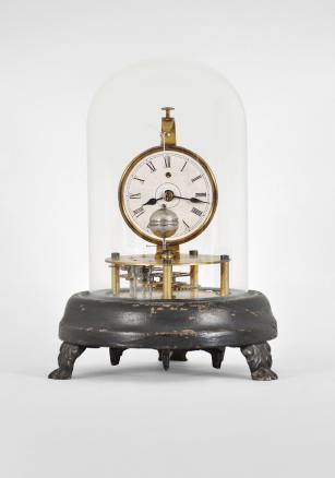 E.N. Welch Mfg. Co., Forestville, Conn., "Briggs Rotary" novelty timepiece with a 30 hour, spring driven brass movement with conical pendulum, 2 inch papered dial with roman numerals, black steel spade hands, all on a black painted wood base with cast metal paw feet and under a small glass dome. These were manufactured under John C. Brigg