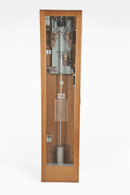 Gents, Leicester, a GPO #36 MK6 master clock, rectilinear hardwood case with rounded corners and glazed door, movement with heavy cast iron back plate, fitted with two count wheels, and contacts at the top of the pendulum sending pulses at one, six, and thirty second intervals, pendulum with heavy cylindrical bob and Hipp toggle, and weight for fine timing, the inner left side of case with two brackets for retaining the pendulum rod while in transit