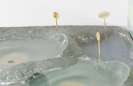 Popular Games Inc., Minneapolis, Minn., "Hoot-Mon" golf nickel arcade / skill game, made in three cabinet versions, A, B, C, golfing action figure wearing red sweater playing three holes of a par five course with painted scenery, two levers to control angle and swing and slot to accept nickel, all contained in a walnut and glass case