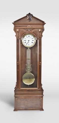 Jewelers standing regulator retailed by M.L. Sheehan, New York, New York, 8 day, time only, weight driven movement with Swiss pinwheel escapement, center seconds and gridiron lyre pendulum bearing a plaque marked M.L. Sheehan, New York , all in a carved walnut case with burl walnut highlights and white enamel dial.