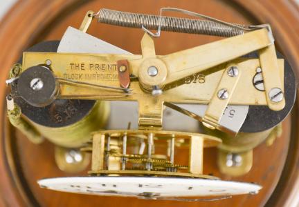 Clocks- 2 (Two), both electromechanical, the first signed "Electric- Silentia Besancon", polished brass crystal regulator style case with mirrored back, roman numeral white enamel dial with black steel hands, round, jeweled watch movement with large balance with horseshoe magnet and rotor below, rewinding the small mainspring barrel every 45 minutes, serial #64, the other by the "Prentiss Clock Improvement Co.", arabic numeral white enamel dial and round brass pin lever movement mounted to a strip brass frame, flanked by two electromagnetic coils, periodically energized and resetting a pivoted horizontal bar with coil spring, it