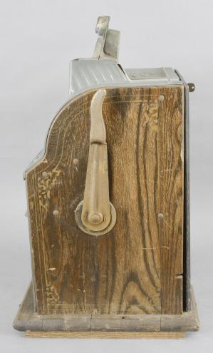 Mills Novelty Company, Chicago, Illinois, "Owl"/ "1776" model, quarter playing, one armed, three wheel slot machine in a oak, nickel, and brass case with painted highlights