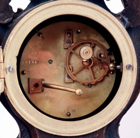 France, conical "mysterious" clock, the patinated spelter case with fluted base and rounded ends, the front festooned with roses and supporting the central clock case, with flanking draped putto, his outstretched arm supporting the gilt conical pendulum, opposite a portrait, easel, and laurel wreath, skeletonized Roman numeral, signed white enamel dial, blued steel Breguet style hands, brass, 8 days, time and strike movement, c1880
