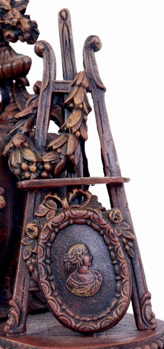 France, conical "mysterious" clock, the patinated spelter case with fluted base and rounded ends, the front festooned with roses and supporting the central clock case, with flanking draped putto, his outstretched arm supporting the gilt conical pendulum, opposite a portrait, easel, and laurel wreath, skeletonized Roman numeral, signed white enamel dial, blued steel Breguet style hands, brass, 8 days, time and strike movement, c1880