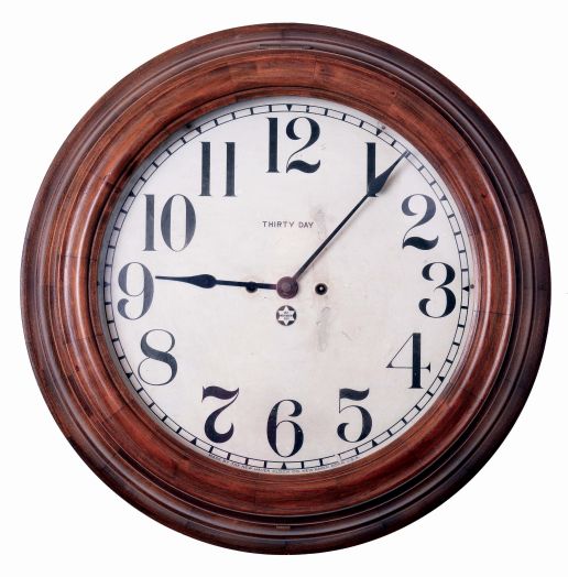 New Haven Clock Co., New Haven, Conn., "14" Gallery", wall clock, 30 days, time only, spring driven movement in a hardwood case with walnut finish with a papered metal dial, c1910.
