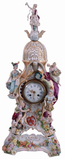 French, porcelain cased mantel clock in the rococo style, the pierced case has gilt and overglaze enamel decoration, the front with four female figures and an eagle with uncooperative legs, all surmounted by another female figure, standing on a winged globe, and resting on a matching porcelain base, Roman numeral white enamel dial with gilt Louis XV style hands, 8 days, pendule a Paris movement striking on a bell, and signed "Marti", c1880