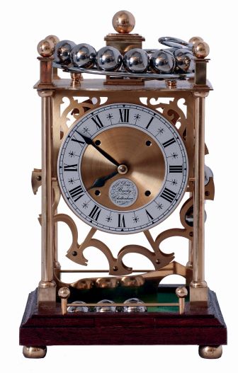 Dove Bazely Ltd., Cheltenham, England, Perpetuum clock, polished brass portico style case with mahogany base, Roman numeral silvered dial, 8 days, timepiece movement powered by a spring, and 24 steel balls, which drop from the rail on the case top onto the "ferris wheel" attached to the winding arbor behind the movement, with paperwork, c1986