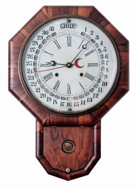 Gilbert Manufacturing Co., Winsted, Conn., "Maranville Calendar Clock " 8 days, time and strike spring driven brass movement drop octagon calendar wall clock, c1865 Label states the clock was made for N. C. Hyde & Co., by Gilbert.